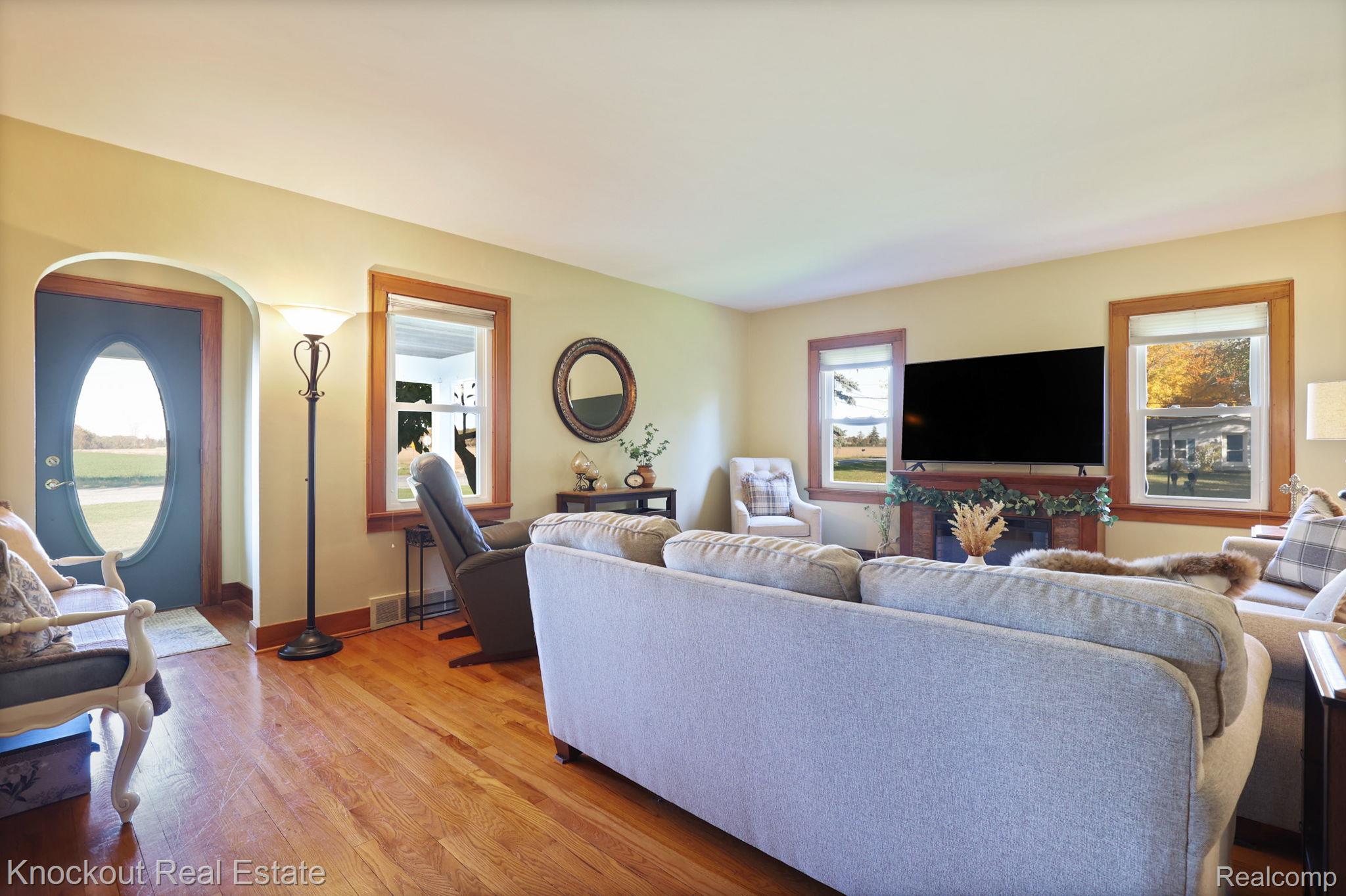 8980 Curtis Road Frankenmuth, MI 48734 - Photo 6 of 56 Living room with light wood-type flooring and arched walkways