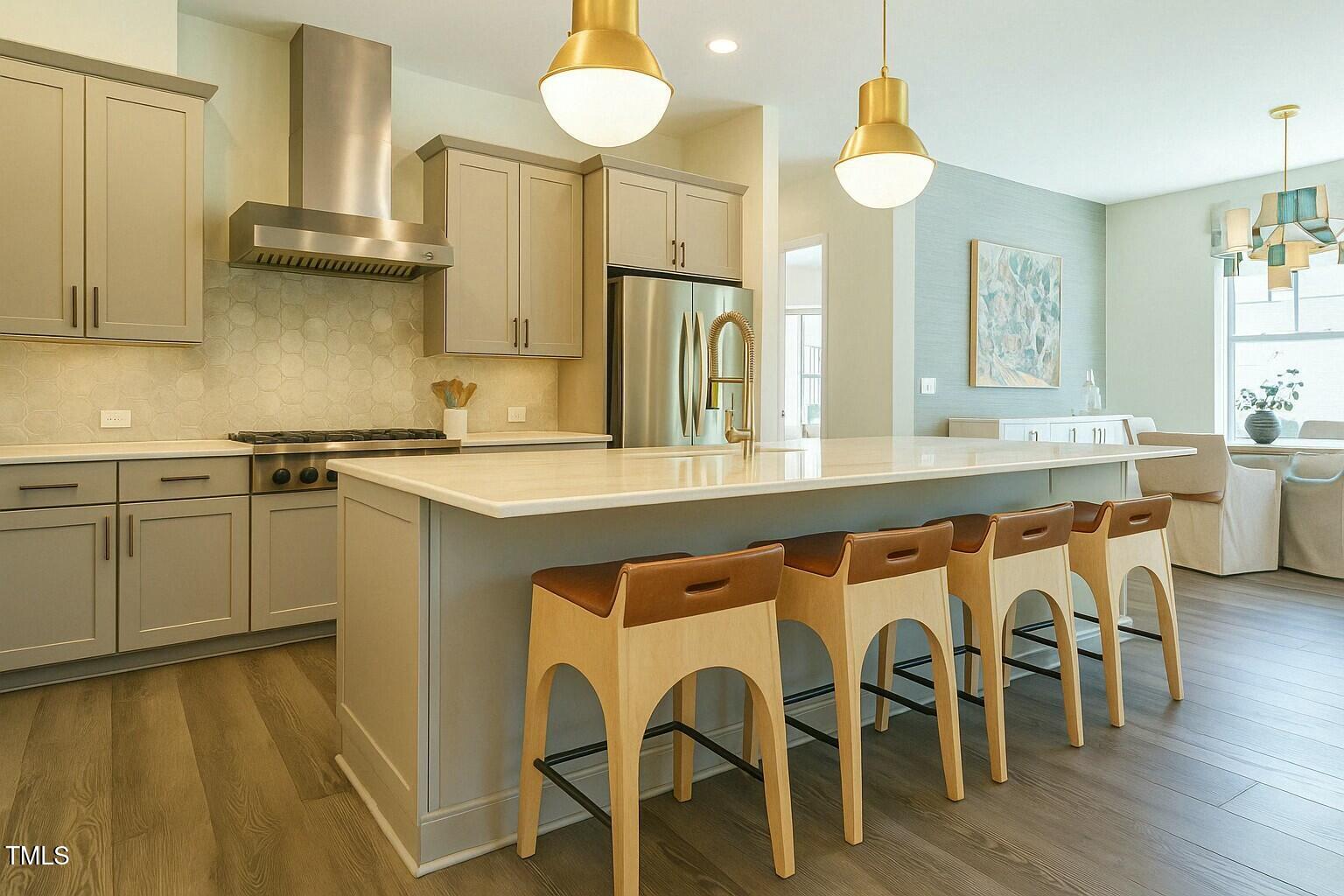 5265 Aleppo Lane Raleigh, NC 27613 - Photo 9 of 45 Infusions of luxury include quartzite countertops, a marble tile backsplash, Visual Comfort lighting, and hardware by Ashley Norton.