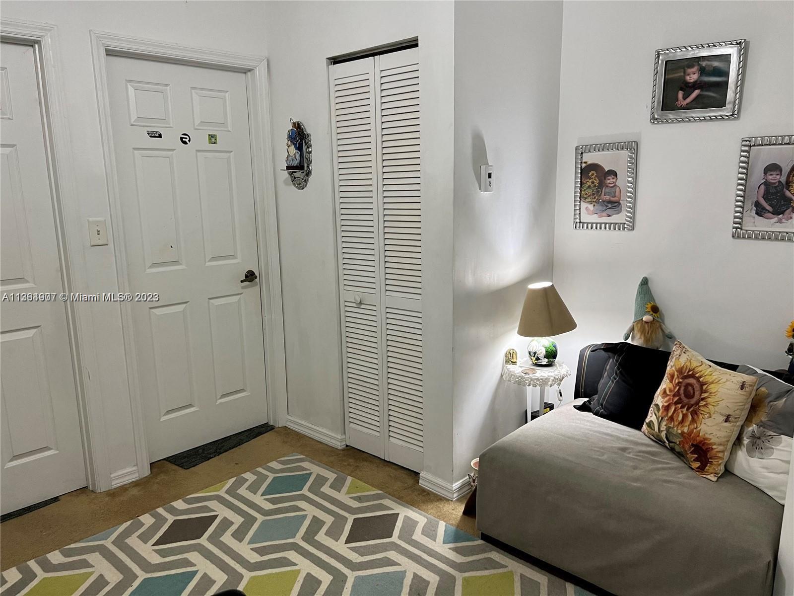 13974 Southwest 260th Street, Unit 102 Homestead, FL 33032 - Photo 9 of 16 a bedroom with a bed and a window