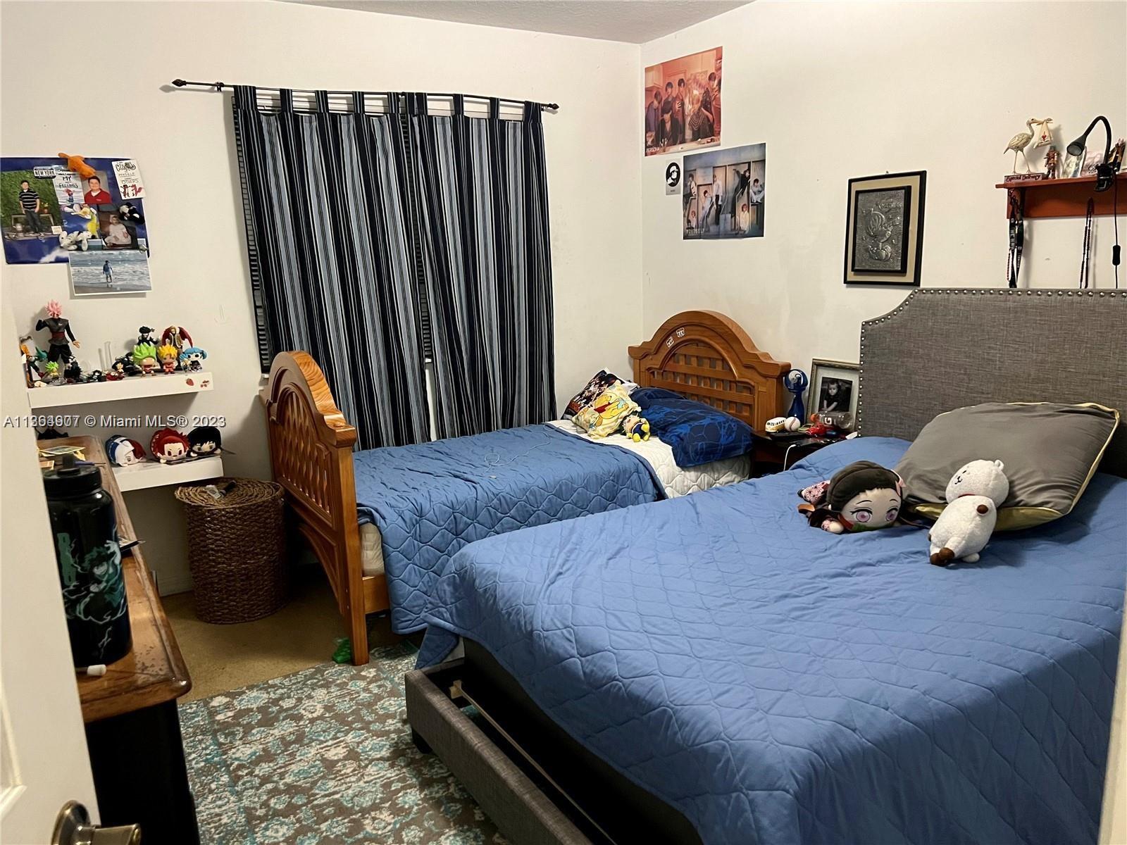 13974 Southwest 260th Street, Unit 102 Homestead, FL 33032 - Photo 10 of 16 a bedroom with bed and a window