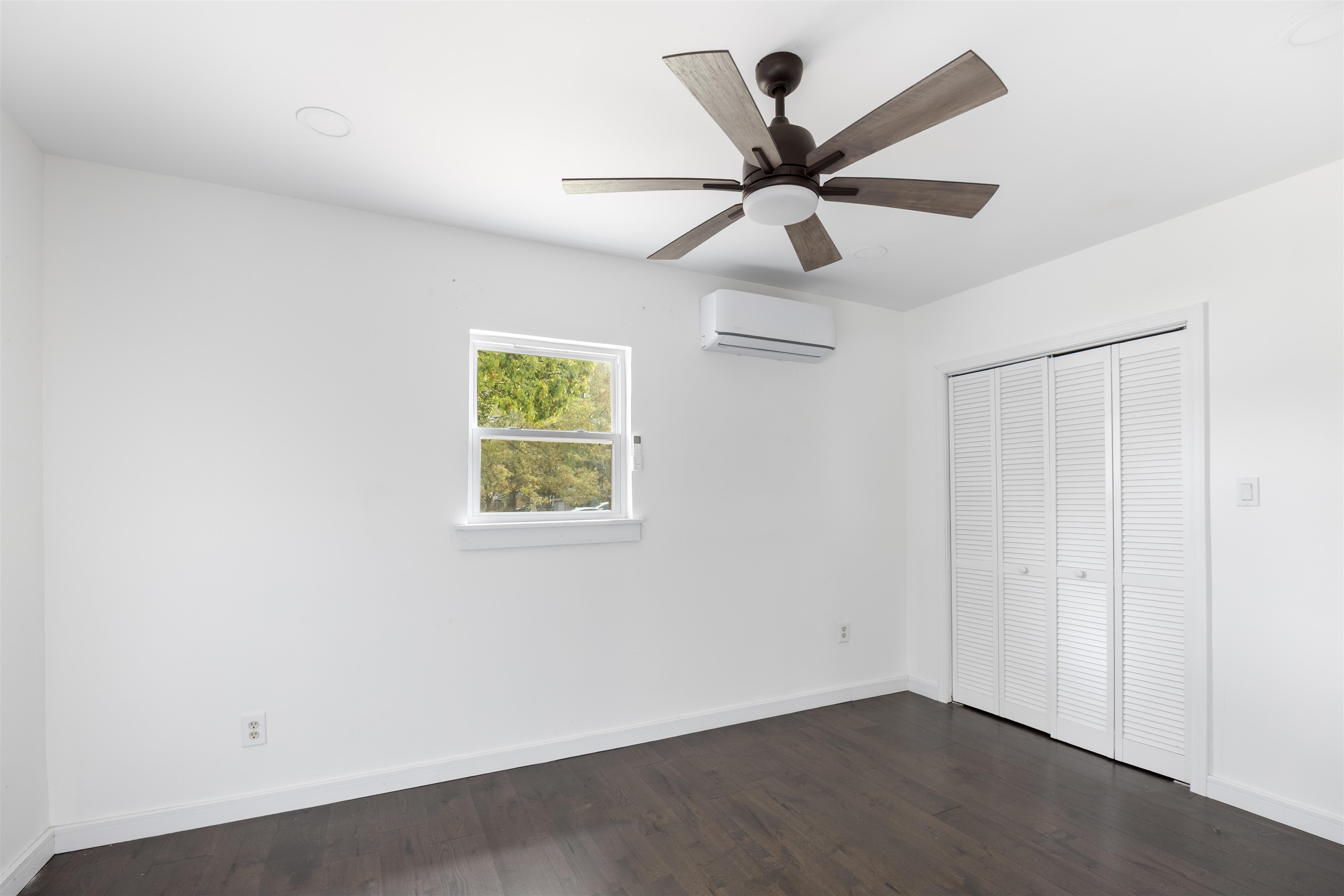 112 South Juniper Street Foley, AL 36535 - Photo 10 of 64 Unfurnished bedroom featuring dark wood-style flooring, a closet, and ceiling fan