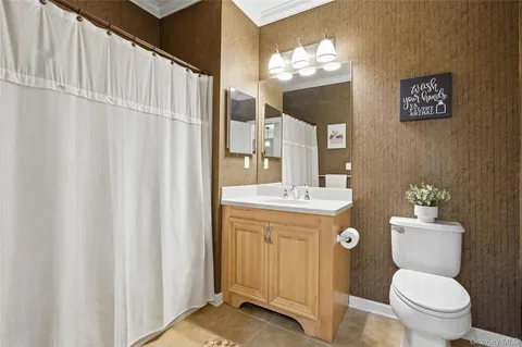 a bathroom with a toilet a sink and a mirror