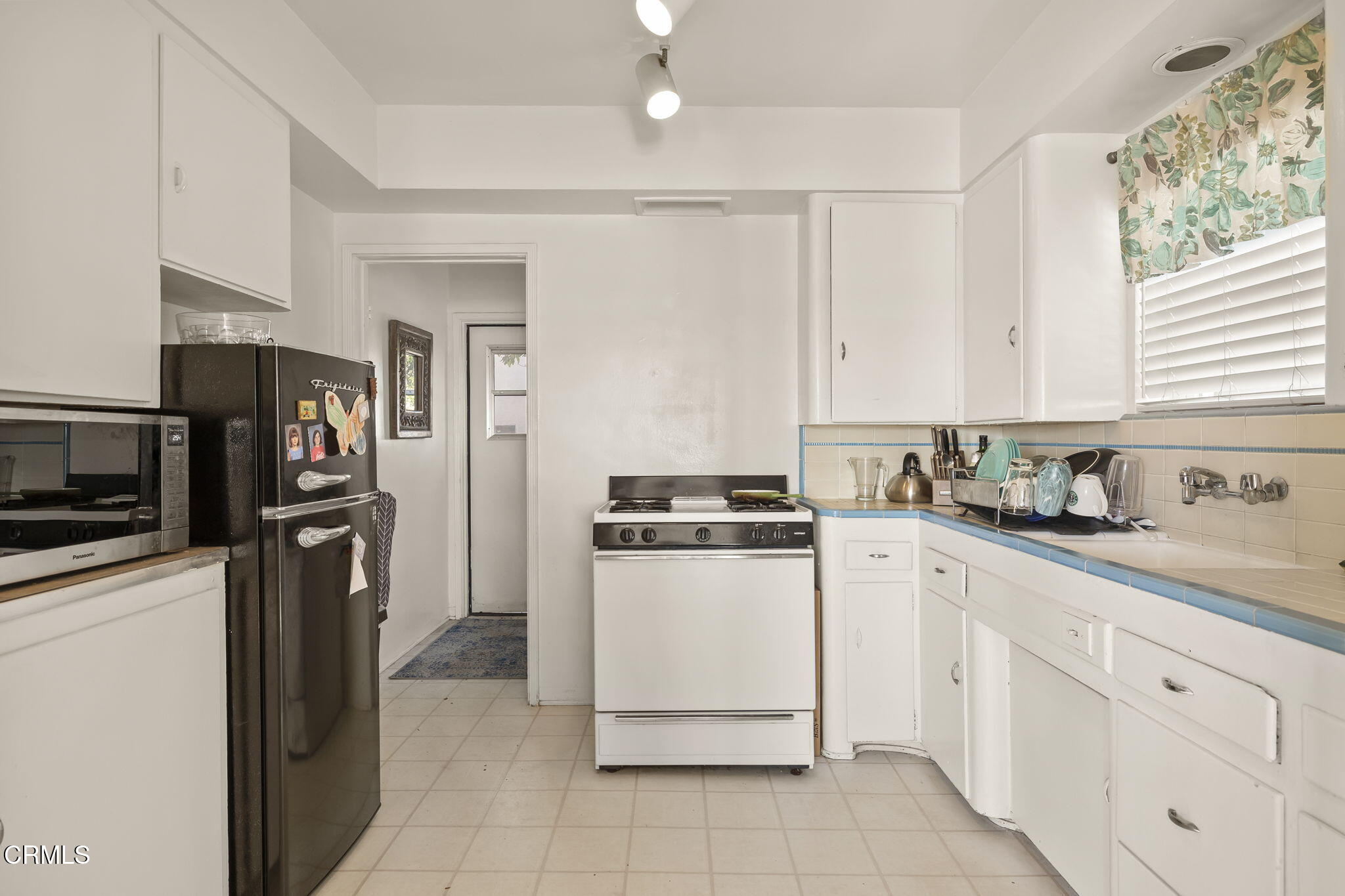 3025 Ocean Drive Oxnard, CA 93035 - Photo 16 of 50 a kitchen with cabinets stainless steel appliances and a window