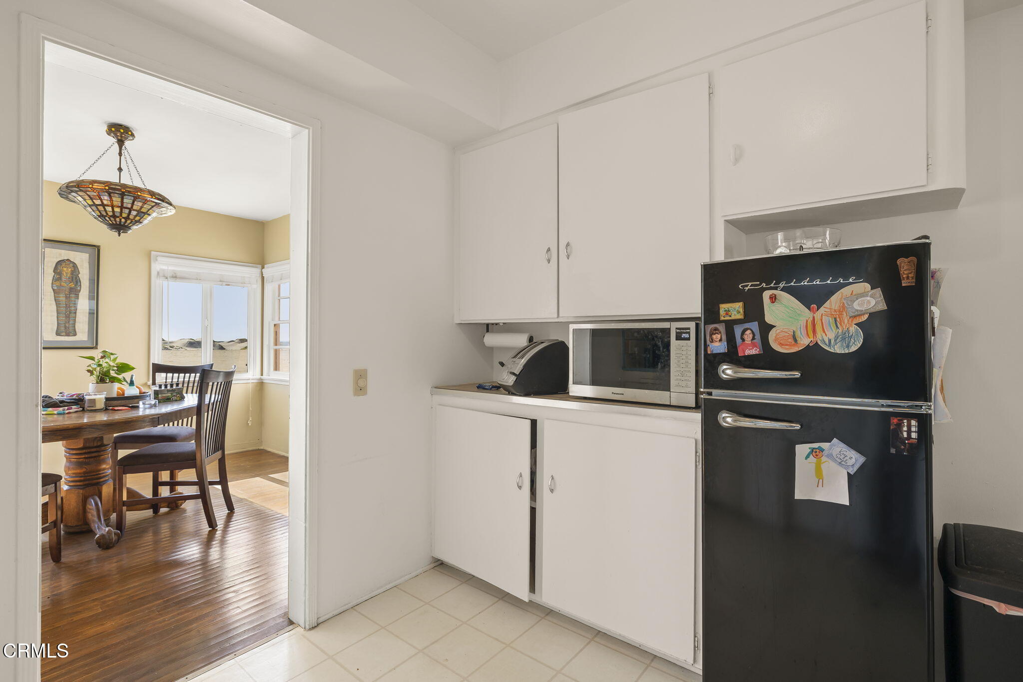 3025 Ocean Drive Oxnard, CA 93035 - Photo 18 of 50 a kitchen with stainless steel appliances a stove a chimney a dining table and chairs