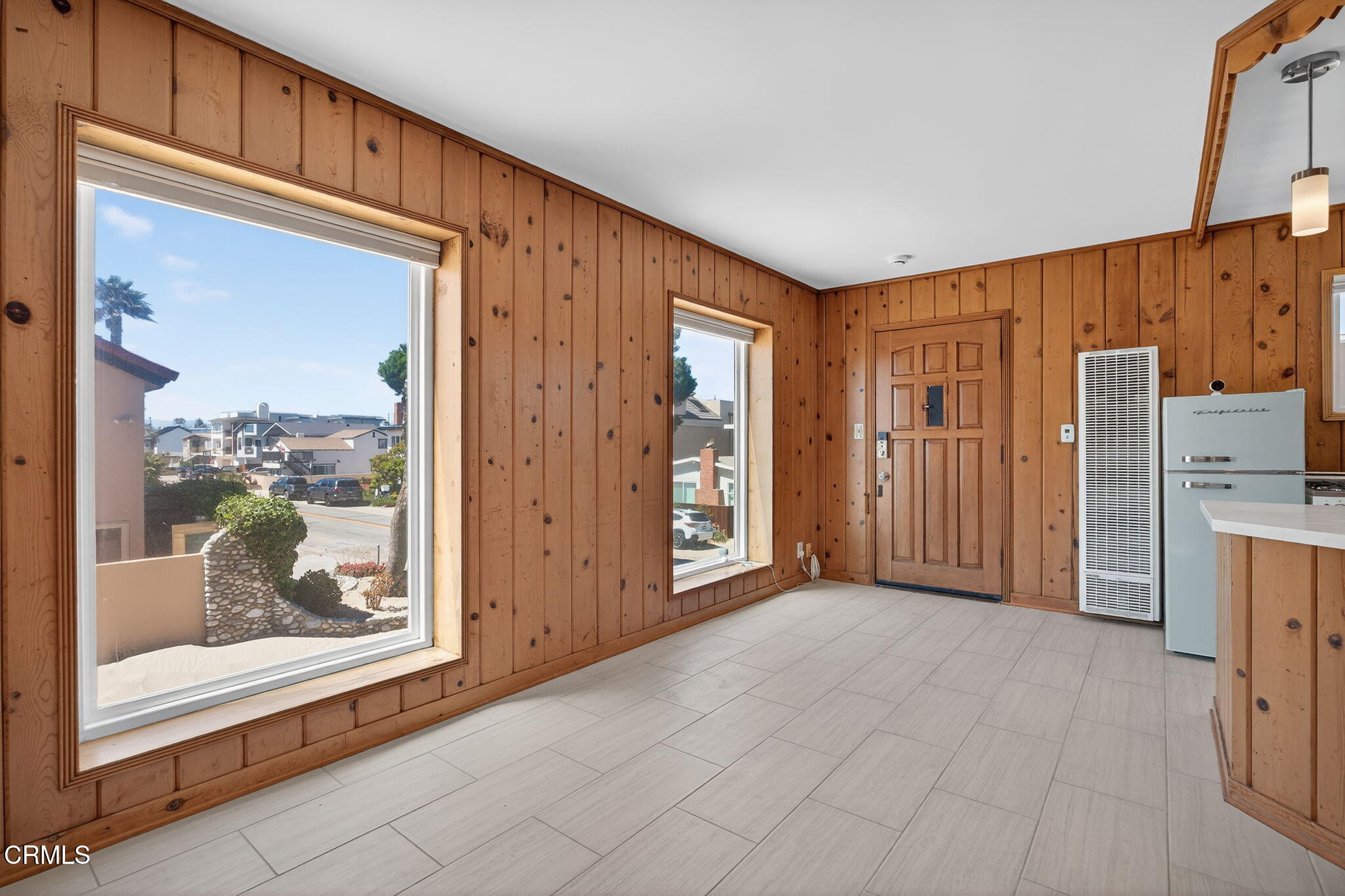 3025 Ocean Drive Oxnard, CA 93035 - Photo 34 of 50 a view of a kitchen with refrigerator and wooden floor