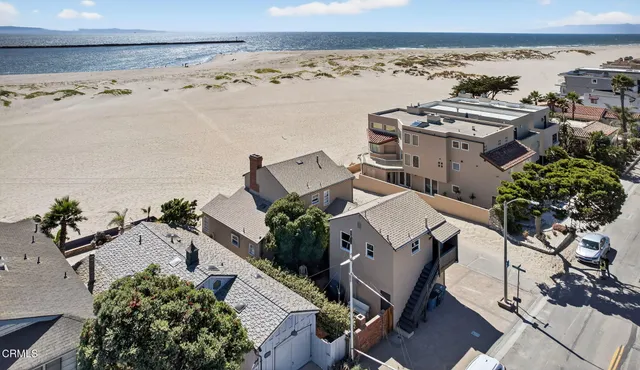 an aerial view of multiple houses with a yard