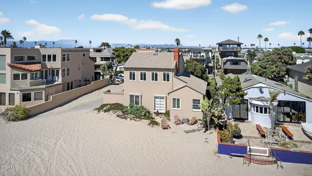 an aerial view of a house with a yard and lake view