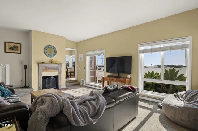 a living room with furniture flat screen tv and a fireplace