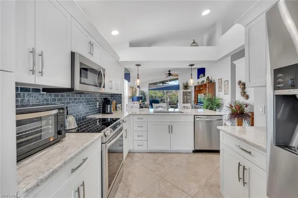 a kitchen with stainless steel appliances granite countertop a stove and cabinets