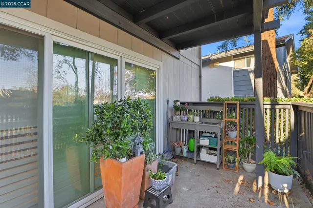 a view of a balcony with flower plants