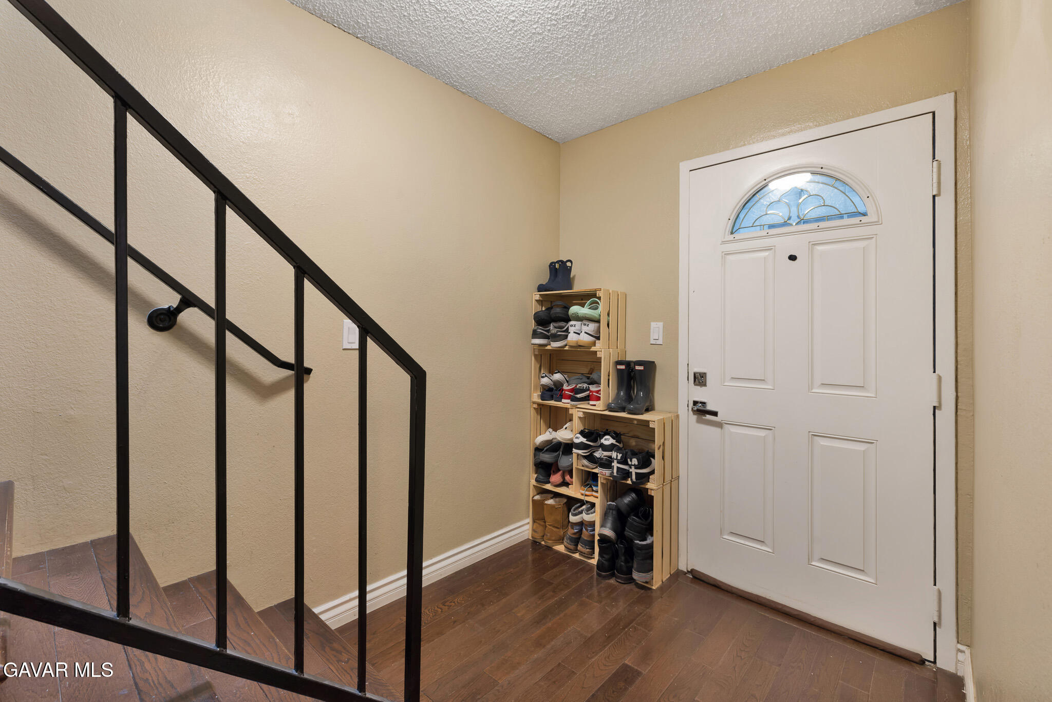 14425 Foothill Boulevard, Unit 17 Sylmar, CA 91342 - Photo 18 of 27 a view of entryway with wooden floor and stairs