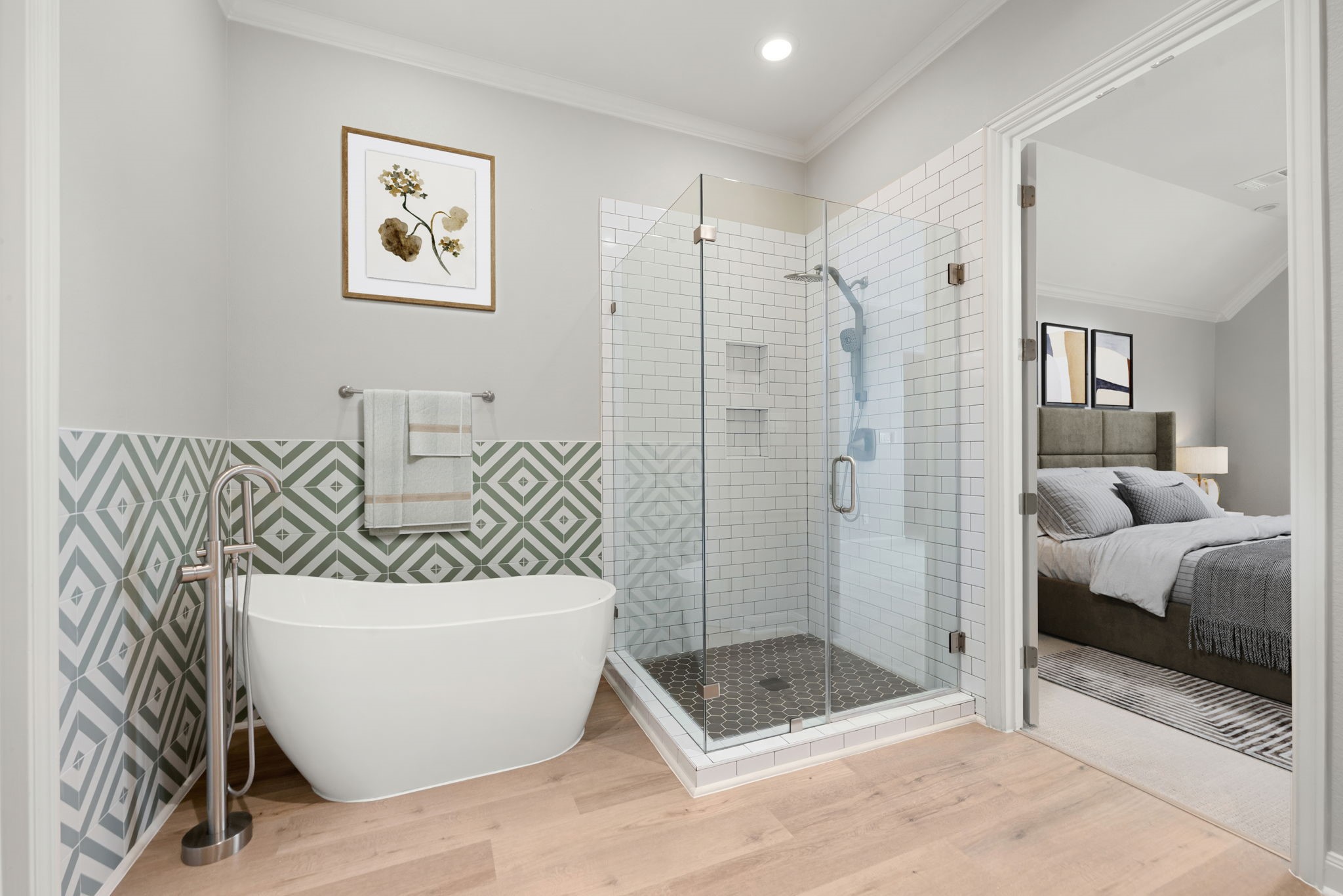 98 Herons Flight Place Spring, TX 77389 - Photo 16 of 29 Spa-inspired primary bath with a freestanding soaking tub, frameless glass shower with dual niches, and eye-catching patterned tile accent wall.