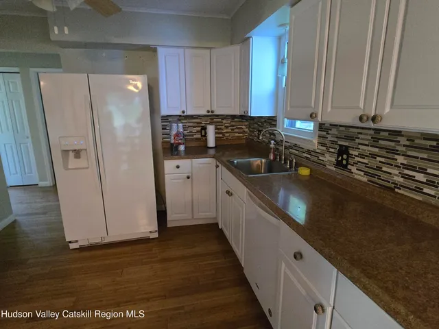 a kitchen with stainless steel appliances a refrigerator sink and cabinets