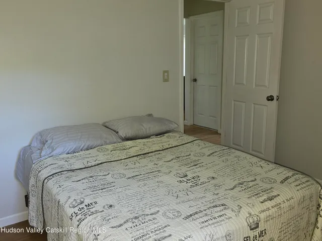 a bedroom with a bed and a shower