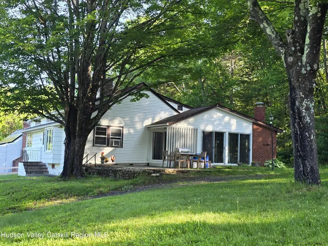 a front view of house with yard and green space