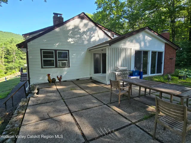 a front view of house with yard outdoor seating and barbeque oven