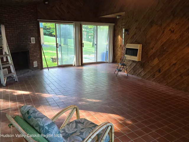a view of a living room with hardwood floor and a flat screen tv