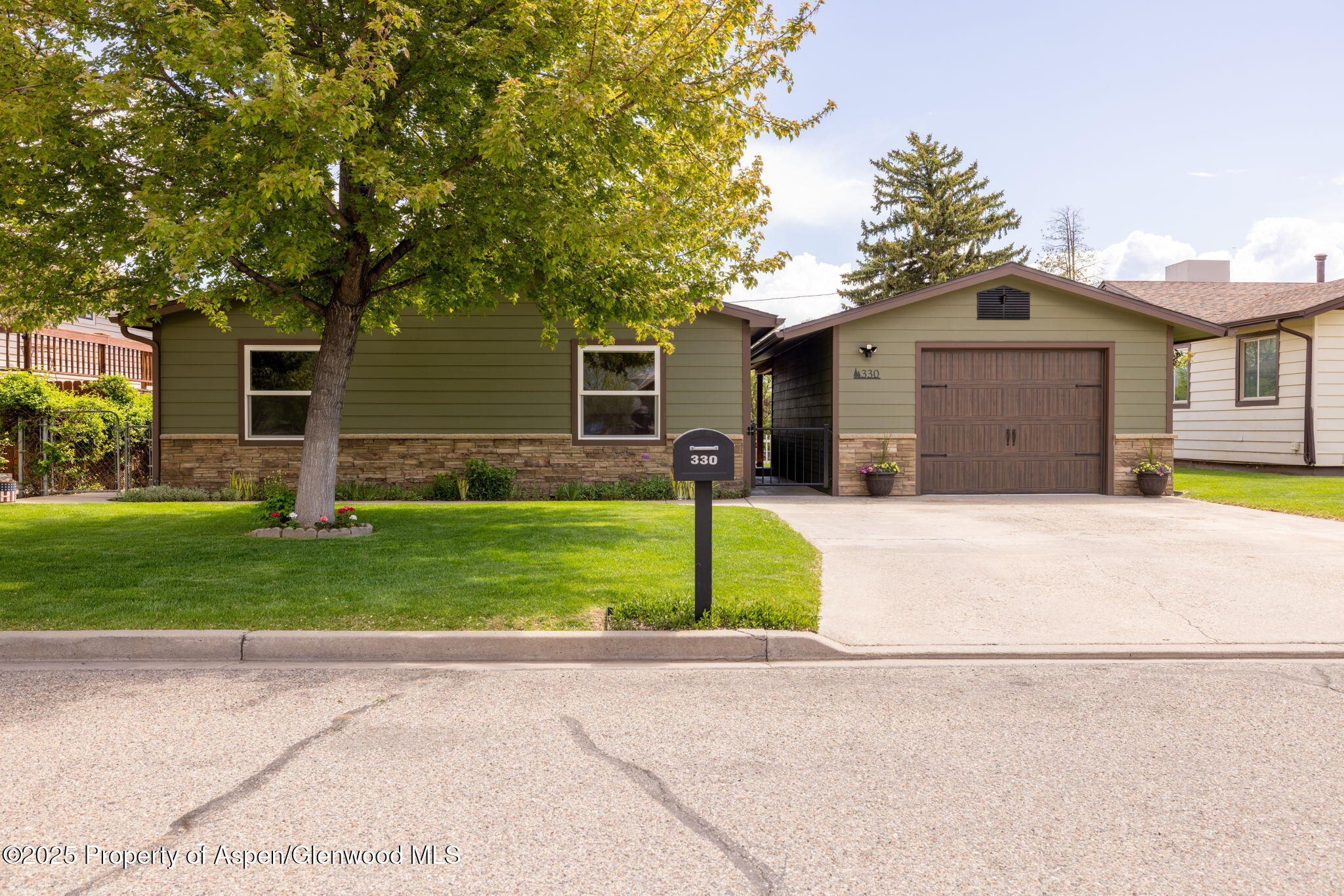 330 Will Avenue Rifle, CO 81650 - Photo 1 of 27 a front view of house with yard and green space