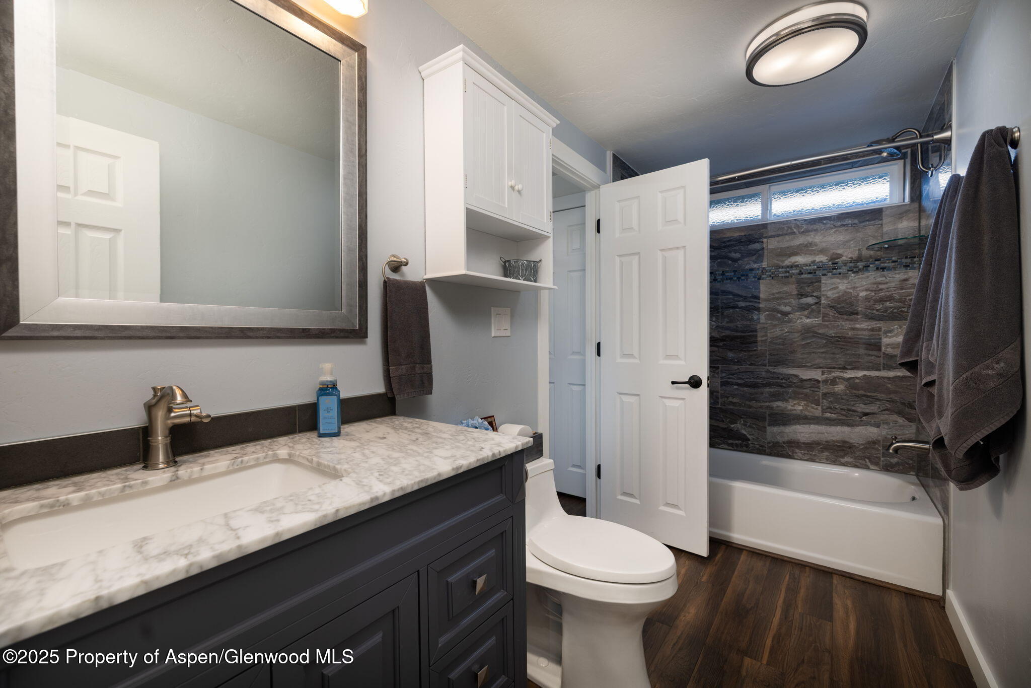 330 Will Avenue Rifle, CO 81650 - Photo 18 of 27 a bathroom with a granite countertop sink toilet and shower