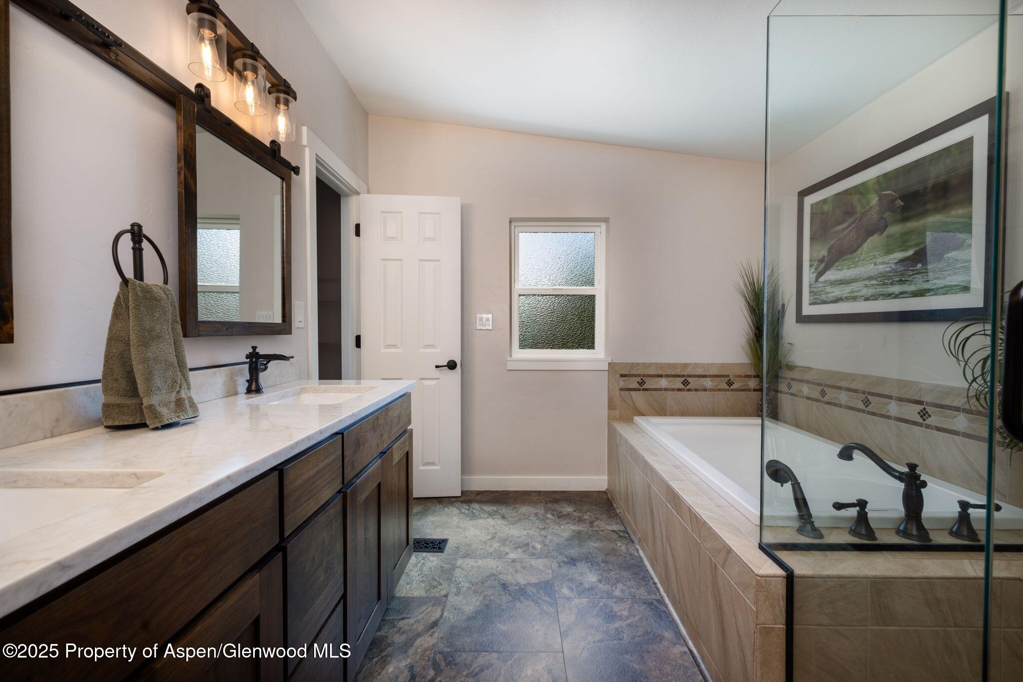 330 Will Avenue Rifle, CO 81650 - Photo 21 of 27 a bathroom with a tub sink and mirror