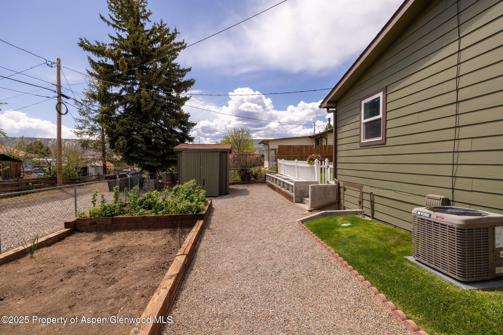 330 Will Avenue Rifle, CO 81650 - Photo 26 of 27 a front view of a house with a yard and a garage