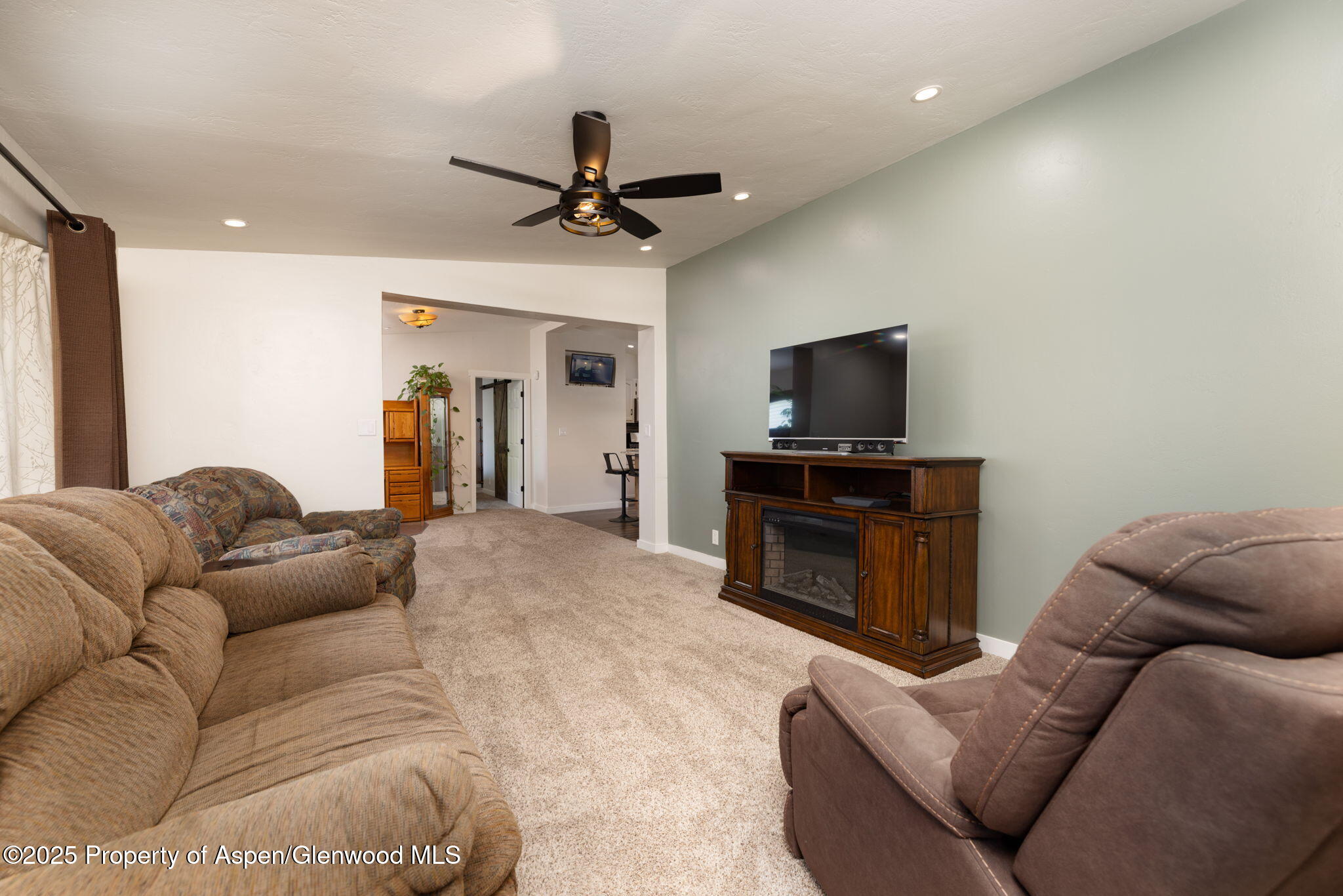 330 Will Avenue Rifle, CO 81650 - Photo 3 of 27 a living room with furniture and a flat screen tv