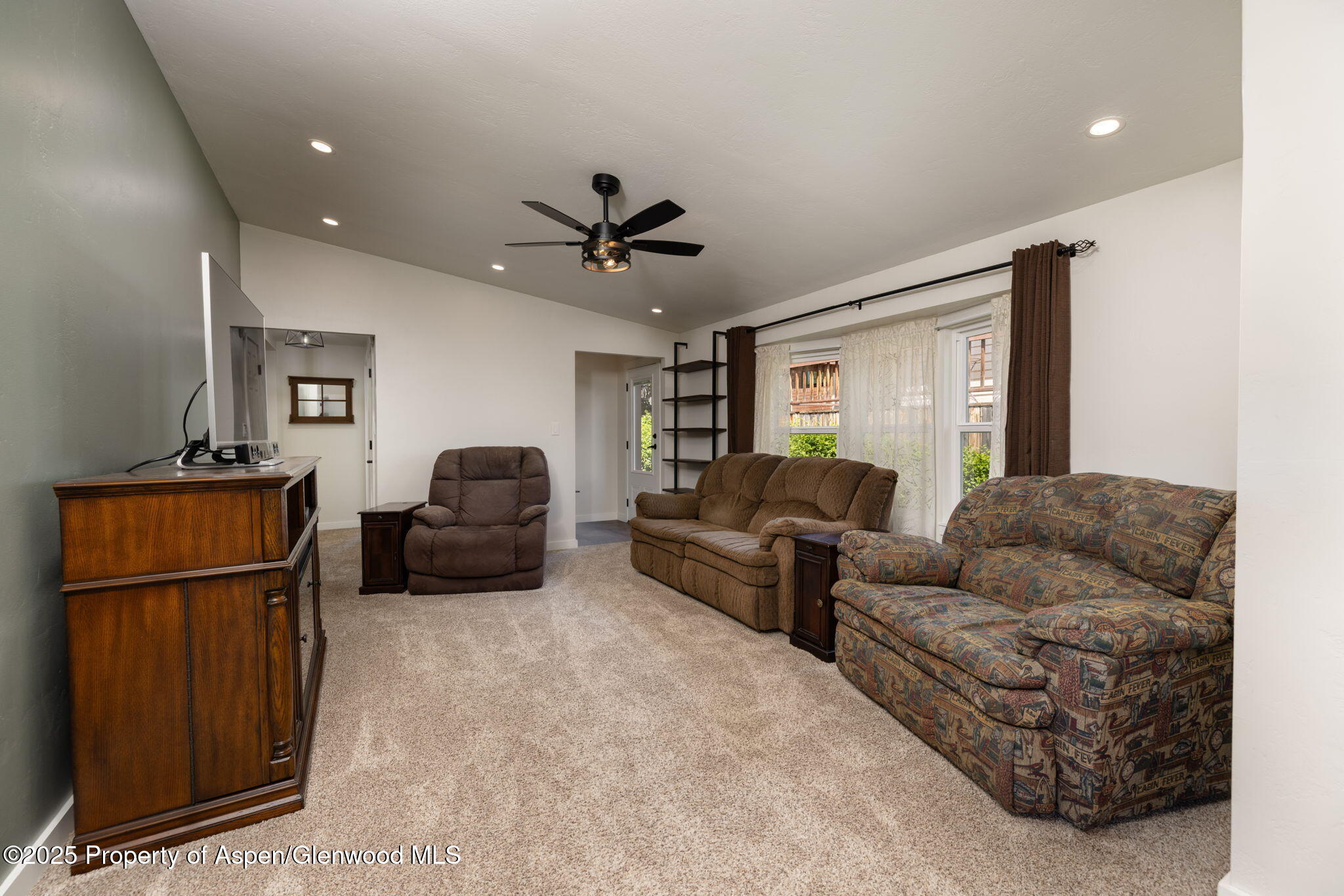 330 Will Avenue Rifle, CO 81650 - Photo 4 of 27 a living room with furniture ceiling fan and a wooden floor