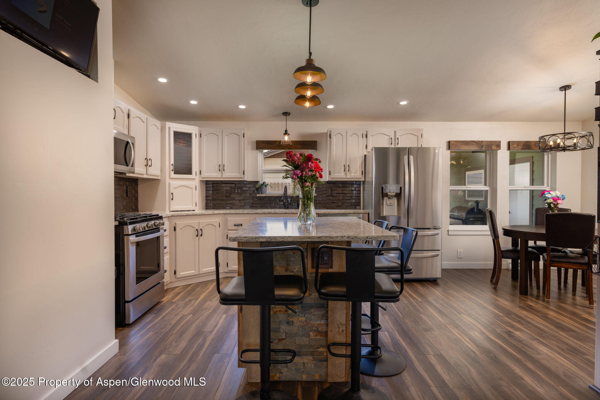 330 Will Avenue Rifle, CO 81650 - Photo 7 of 27 a kitchen with stainless steel appliances a dining table chairs stove and cabinets