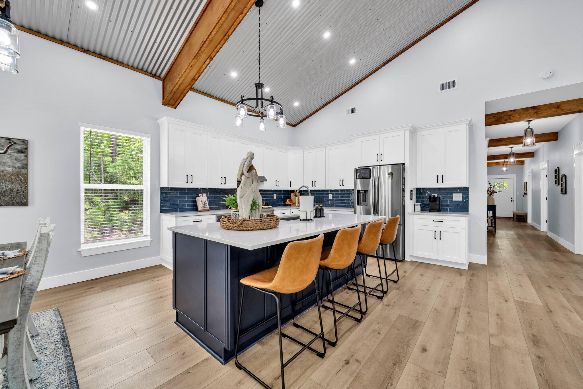 52 Lazy Bone St Point Vernon, FL 32462 - Photo 27 of 62 a living room with stainless steel appliances kitchen island a table chairs and a refrigerator