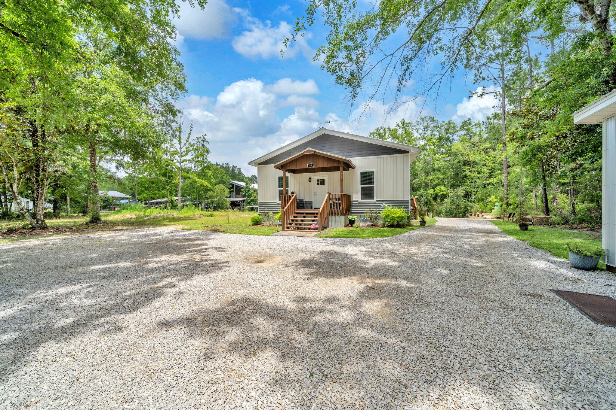 52 Lazy Bone St Point Vernon, FL 32462 - Photo 3 of 62 a front view of a house with a garden