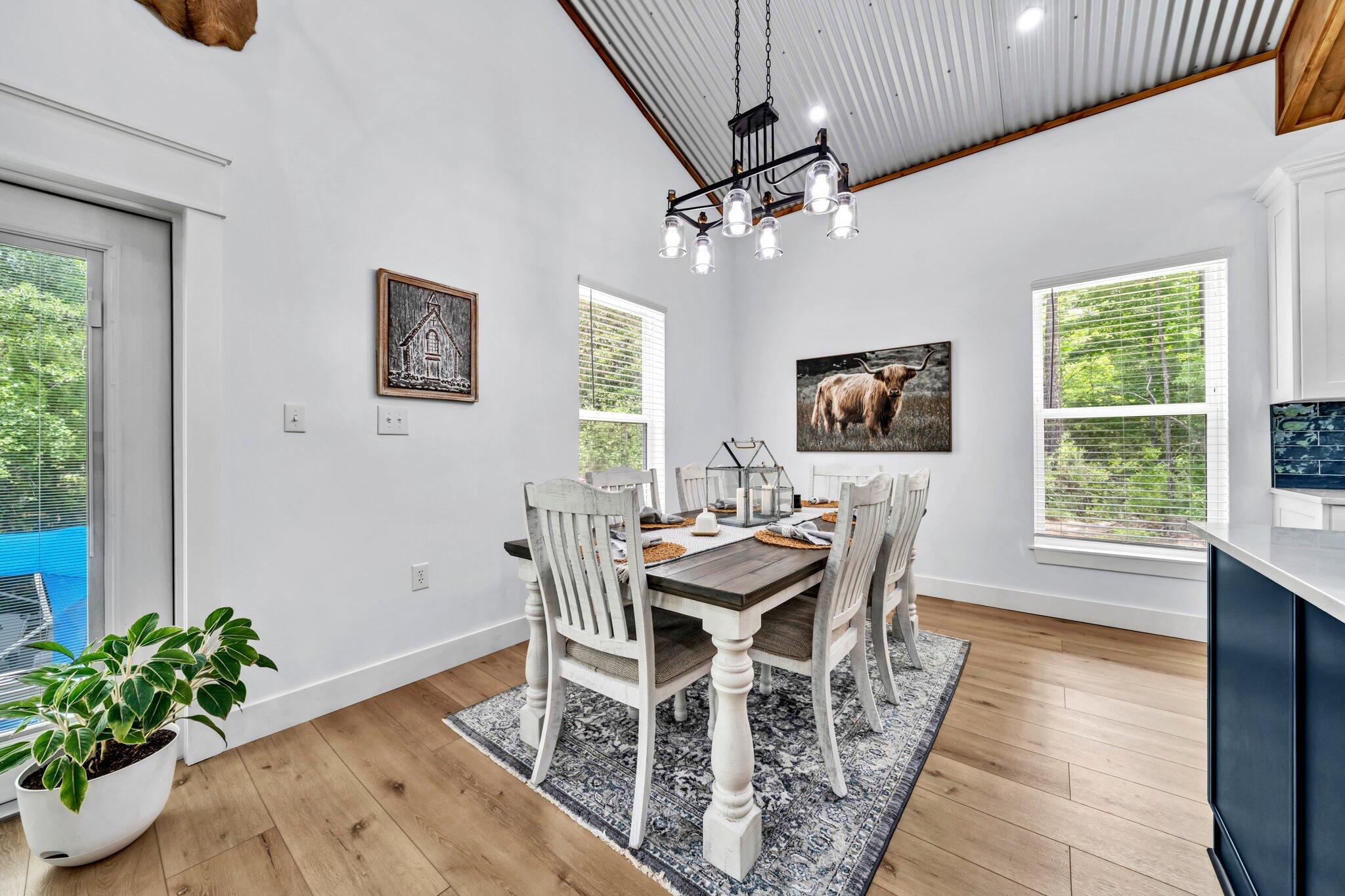 52 Lazy Bone St Point Vernon, FL 32462 - Photo 32 of 62 a dining room with furniture potted plants and wooden floor