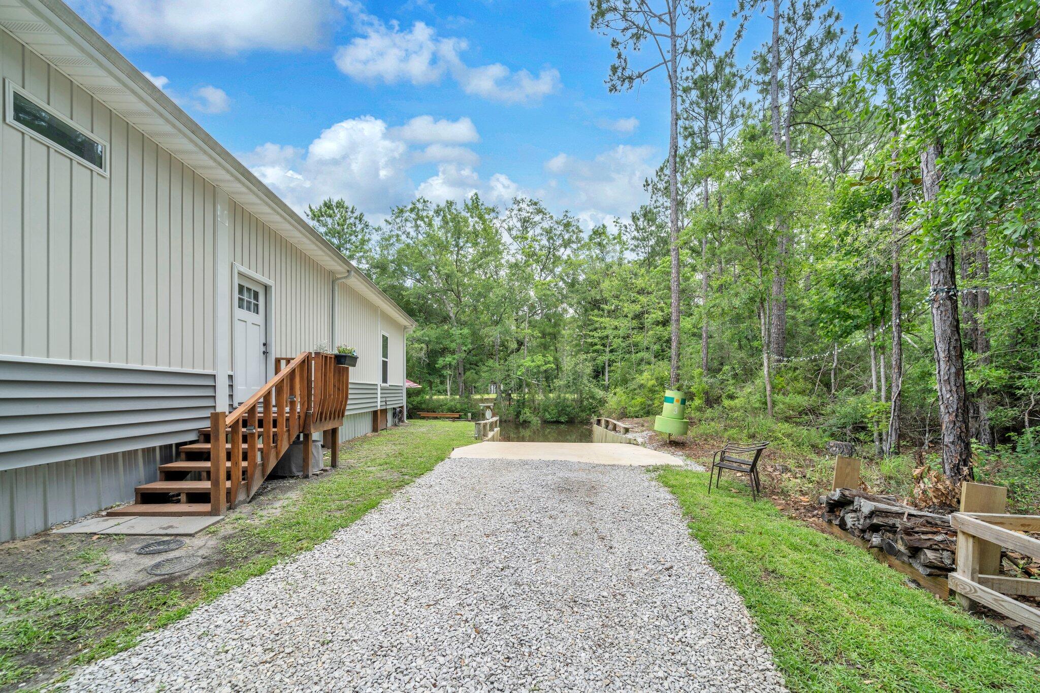 52 Lazy Bone St Point Vernon, FL 32462 - Photo 40 of 62 a view of a house with backyard and trees