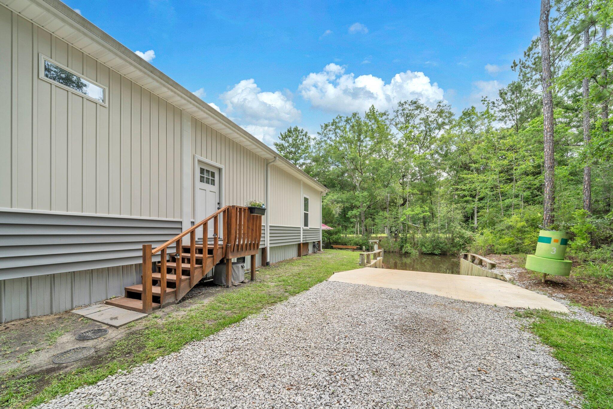 52 Lazy Bone St Point Vernon, FL 32462 - Photo 41 of 62 a view of a house with backyard and sitting area