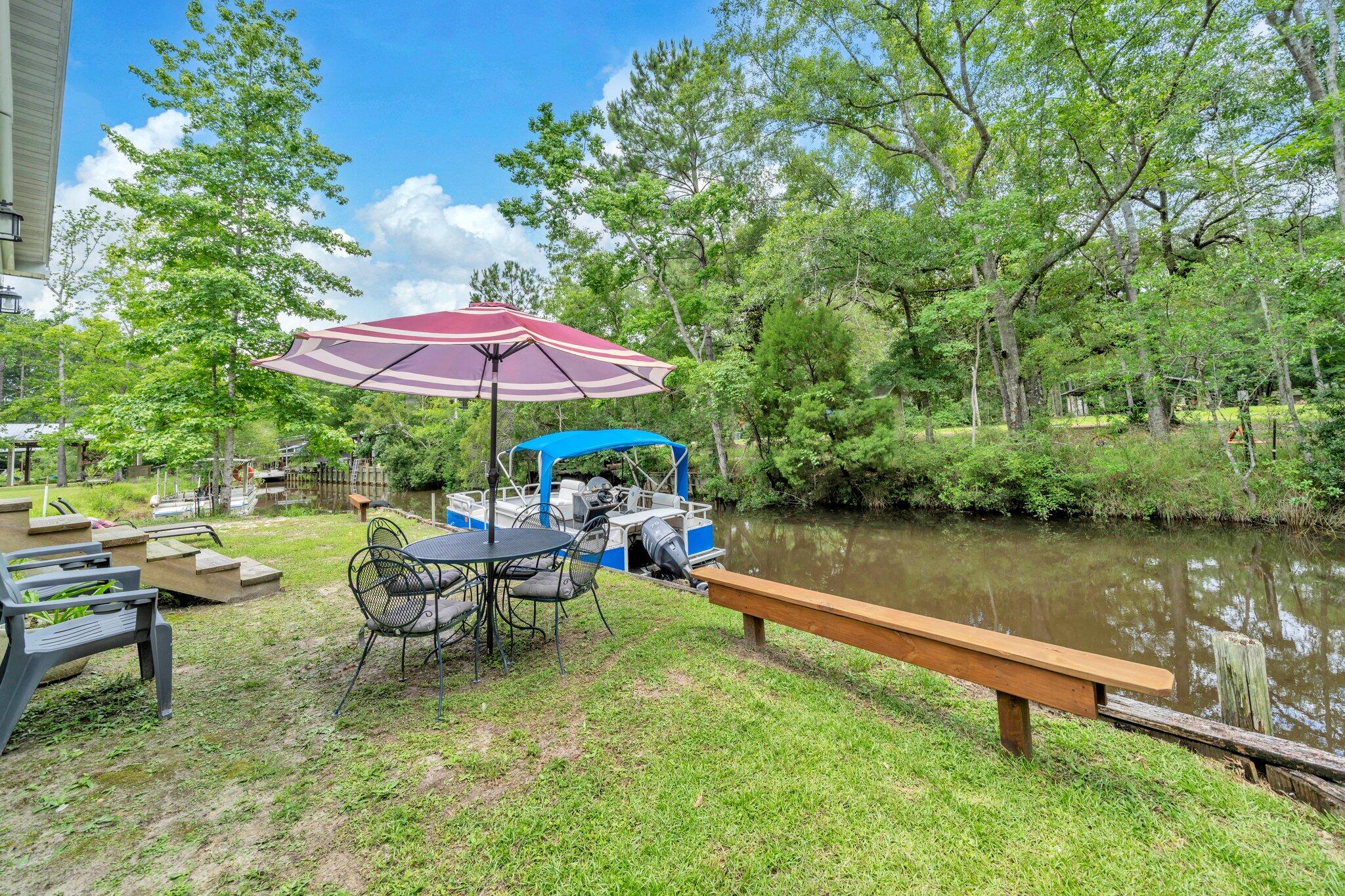 52 Lazy Bone St Point Vernon, FL 32462 - Photo 43 of 62 a view of yard with outdoor seating and trees in the background