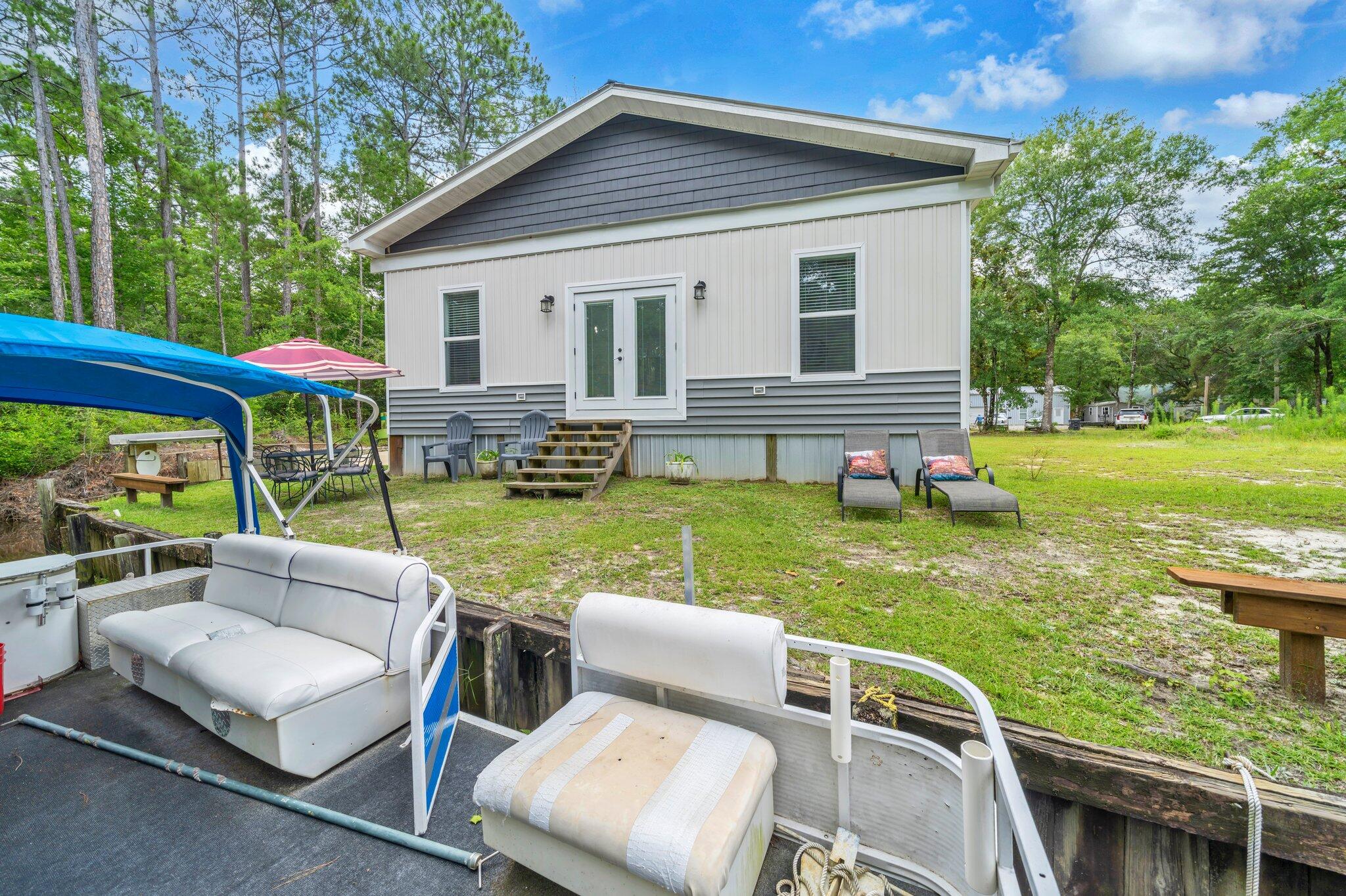 52 Lazy Bone St Point Vernon, FL 32462 - Photo 48 of 62 a view of backyard of house with seating space