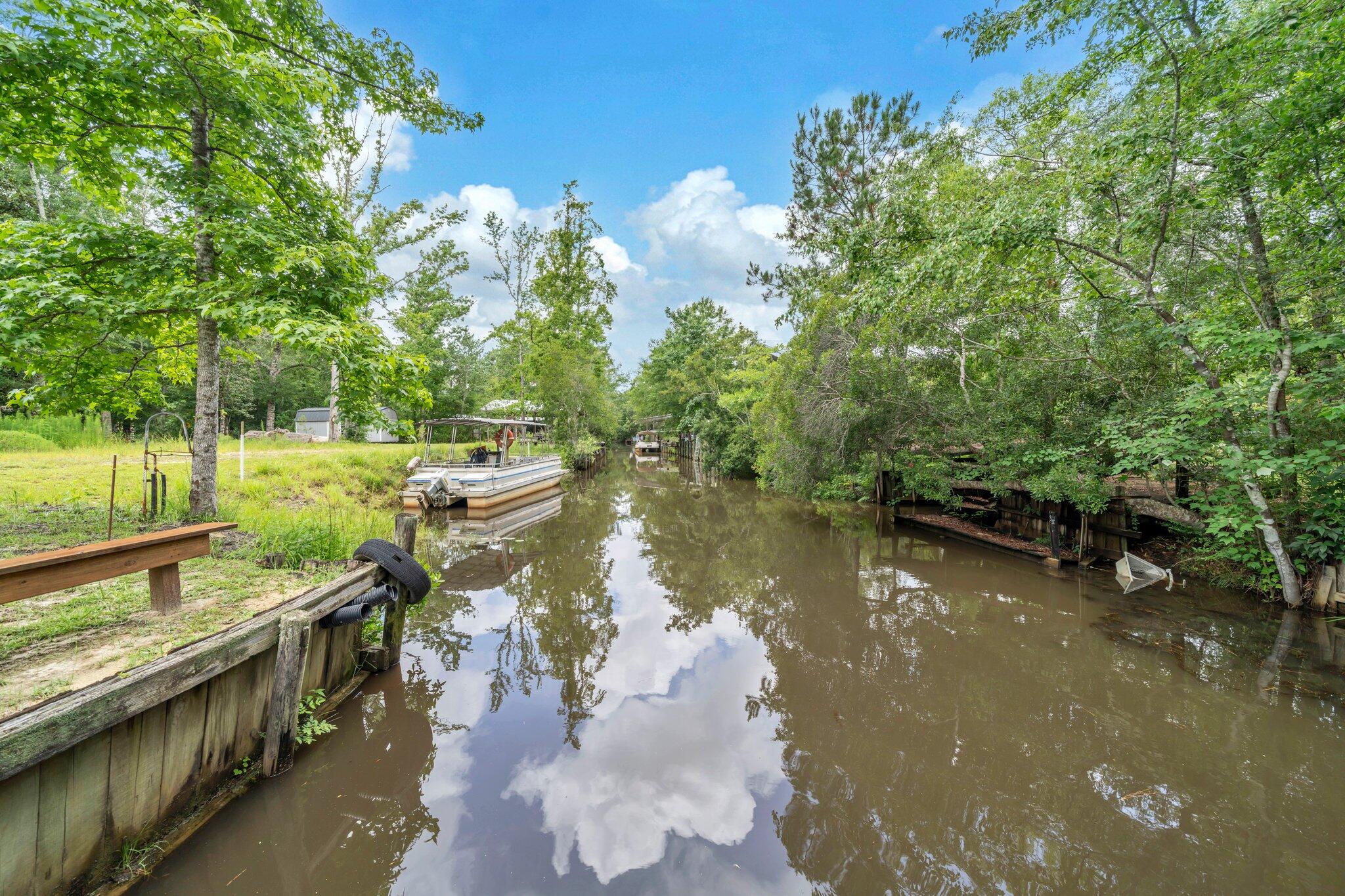 52 Lazy Bone St Point Vernon, FL 32462 - Photo 49 of 62 a view of a lake with a yard and large trees