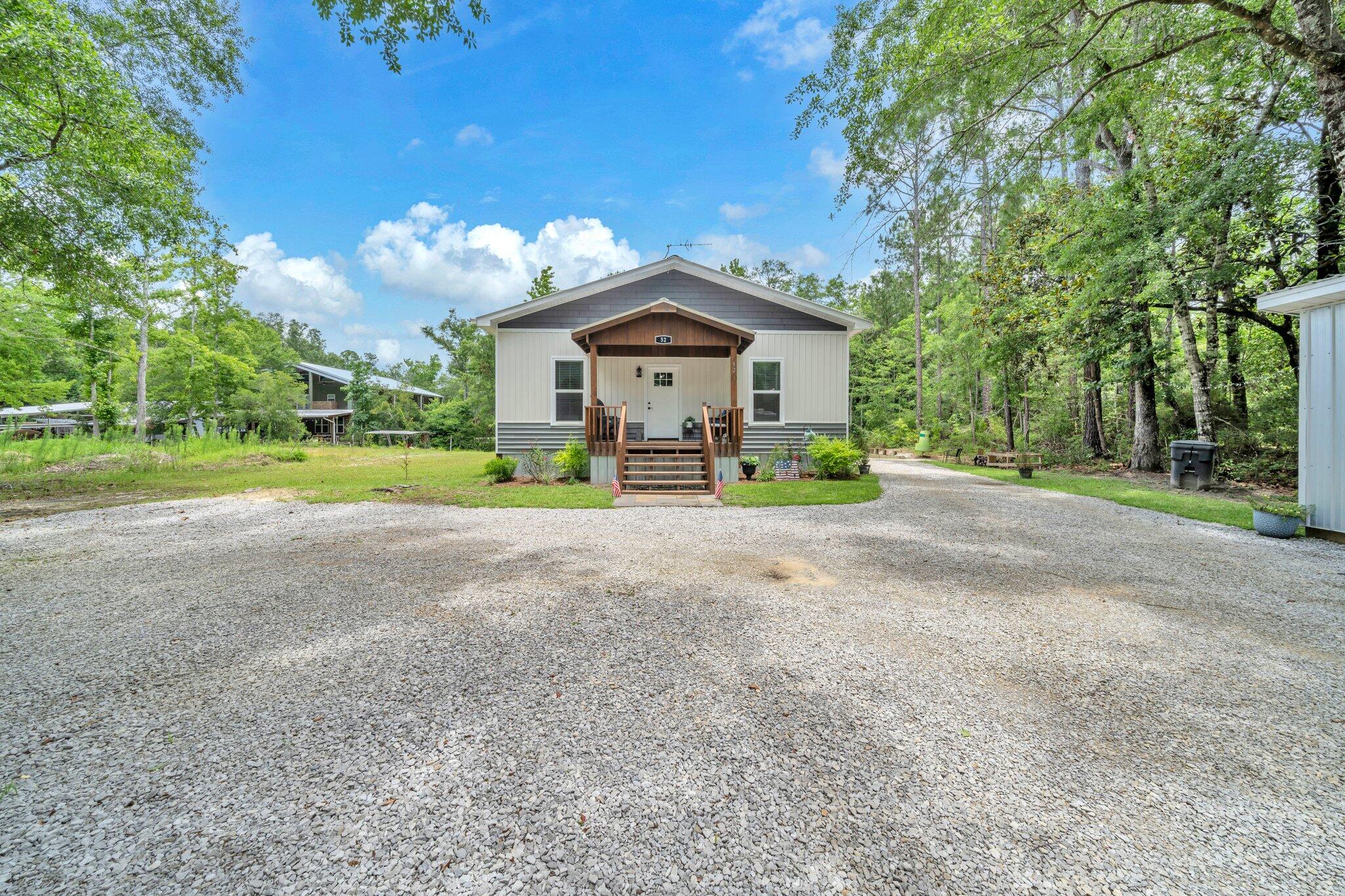 52 Lazy Bone St Point Vernon, FL 32462 - Photo 8 of 62 a view of a house with a big yard and large trees