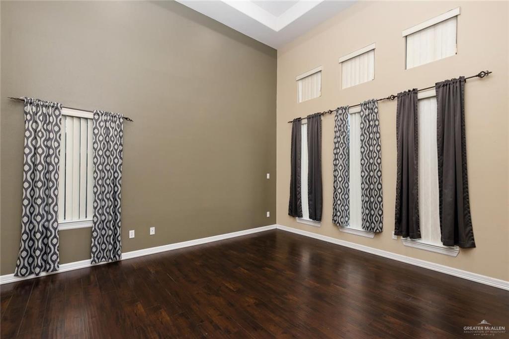 1910 West 41st Street Mission, TX 78573 - Photo 14 of 15 an empty room with wooden floor and windows