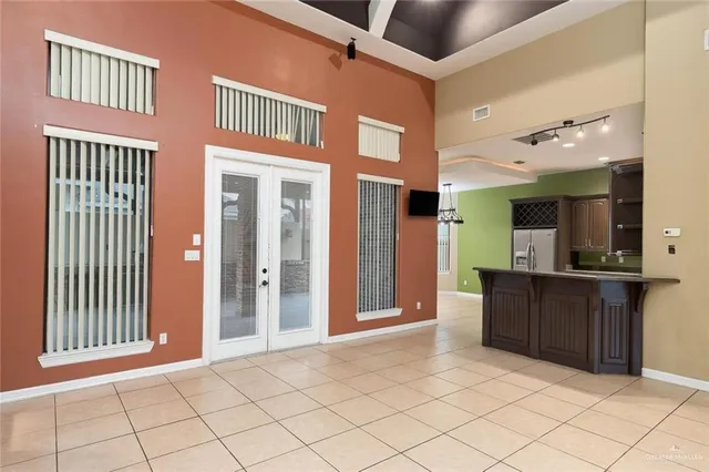 a view of a hallway with a refrigerator and a sink