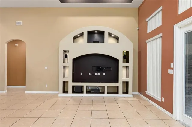 a view of a livingroom with a fireplace and window