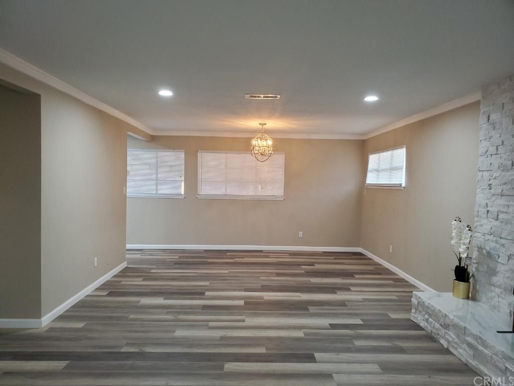 910 West Ave J8 Lancaster, CA 93534 - Photo 21 of 24 a view of an empty room with wooden floor and a window