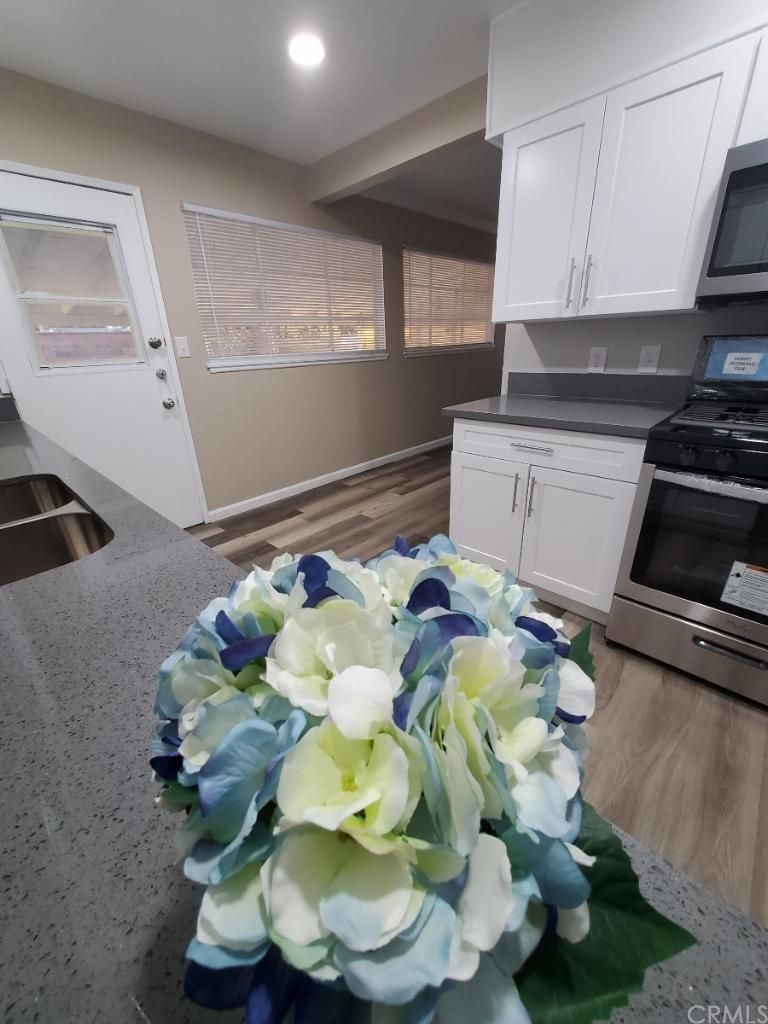 910 West Ave J8 Lancaster, CA 93534 - Photo 5 of 24 a white vase of white and yellow flowers