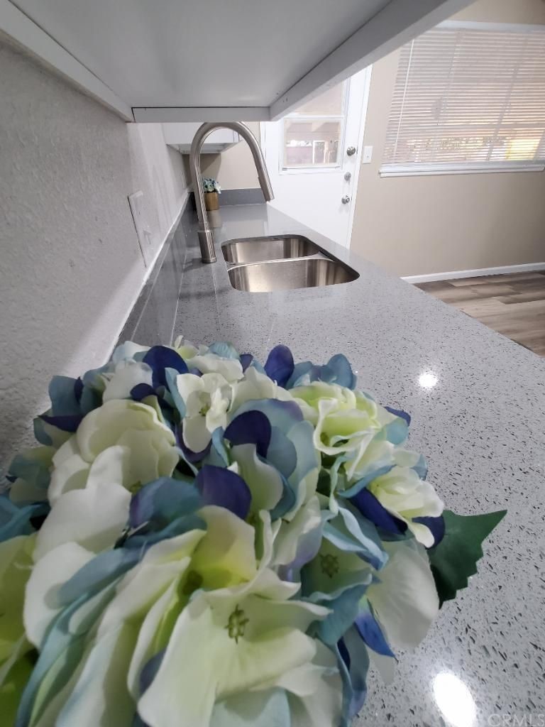 910 West Ave J8 Lancaster, CA 93534 - Photo 7 of 24 a bathroom with a sink mirror and painting on the wall