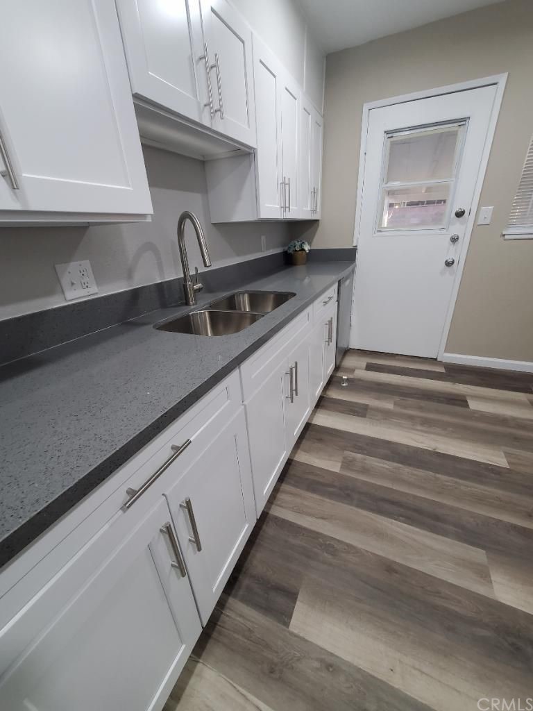 910 West Ave J8 Lancaster, CA 93534 - Photo 10 of 24 a kitchen with granite countertop white cabinets and sink