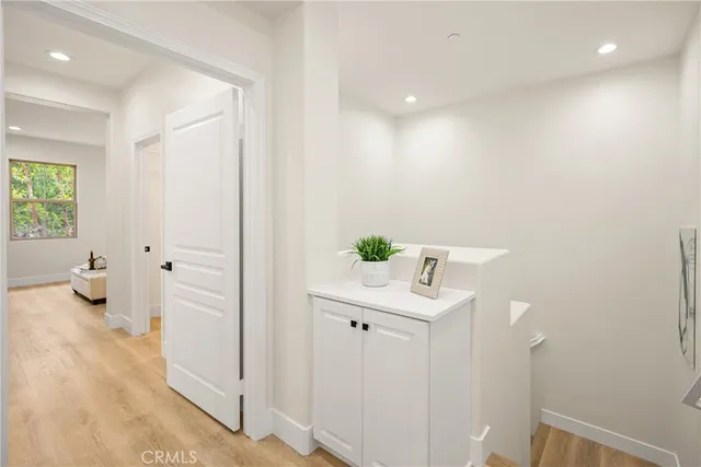 a bedroom with a bed and painting on the wall