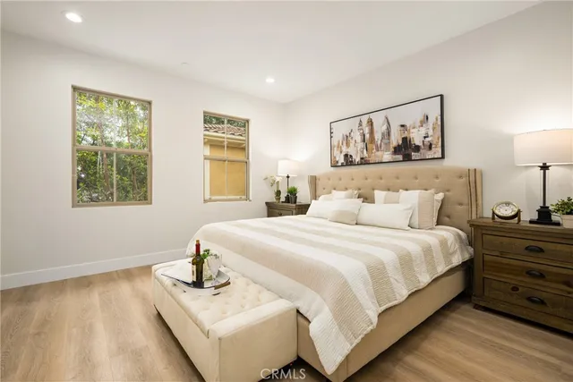 a bedroom with a bed and painting on the wall