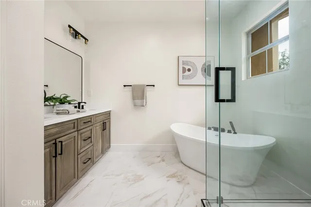 a white bath tub sitting next to a shower