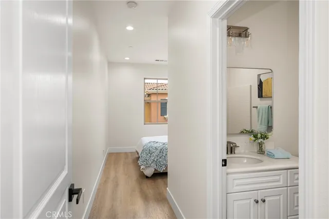 a bedroom with a bed and a painting on the wall