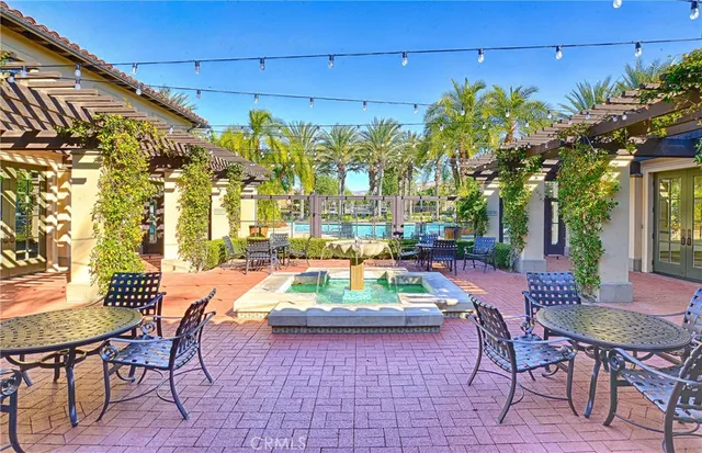 a view of a swimming pool with a lawn chairs and palm tree