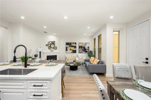 a living room with fireplace furniture and a wooden floor